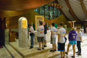 Pilgrims line up to venerate a relic of St. John Paul II during a World Youth Day at home event in the Shrine Chapel of Our Lady of Orchard Lake.