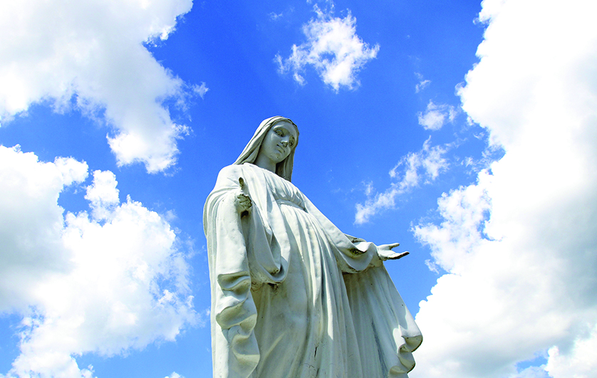 A statue of Mary overlooks the grounds of St. Jude Church in Mastic Beach, N.Y., Aug. 4. The feast of the Assumption of the Blessed Virgin Mary, Aug. 15, celebrates the belief that Mary was taken body and soul into heaven at the end of her life. (CNS photo/Gregory A. Shemitz) (Aug. 6, 2013)