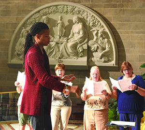 Glen Thomas Rideout leads musicians as a new tympanum depicting St. Anne, Mary and Jesus overlooks the altar of the cathedral.