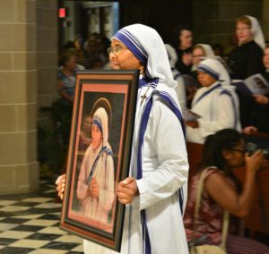 Sr. Brunetta, MC, carries a portrait of St. Teresa of Calcutta in procession to begin a Mass of thanksgiving for St. Teresa's canonization Sept. 4 at the Cathedral of the Most Blessed Sacrament in Detroit. 