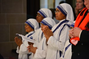 Five Missionaries of Charity pray during a Mass of thanksgiving for the canonization of their founder, St. Teresa of Calcutta. 