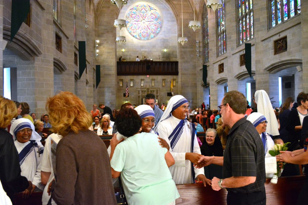 Mass-goers greet and congratulate the five Missionaries of Charity sisters in attendance during a Mass of thanksgiving for the canonization of St. Teresa of Calcutta at the Cathedral of the Most Blessed Sacrament on Sept. 4. (Photos by Mike Stechschulte, The Michigan Catholic)