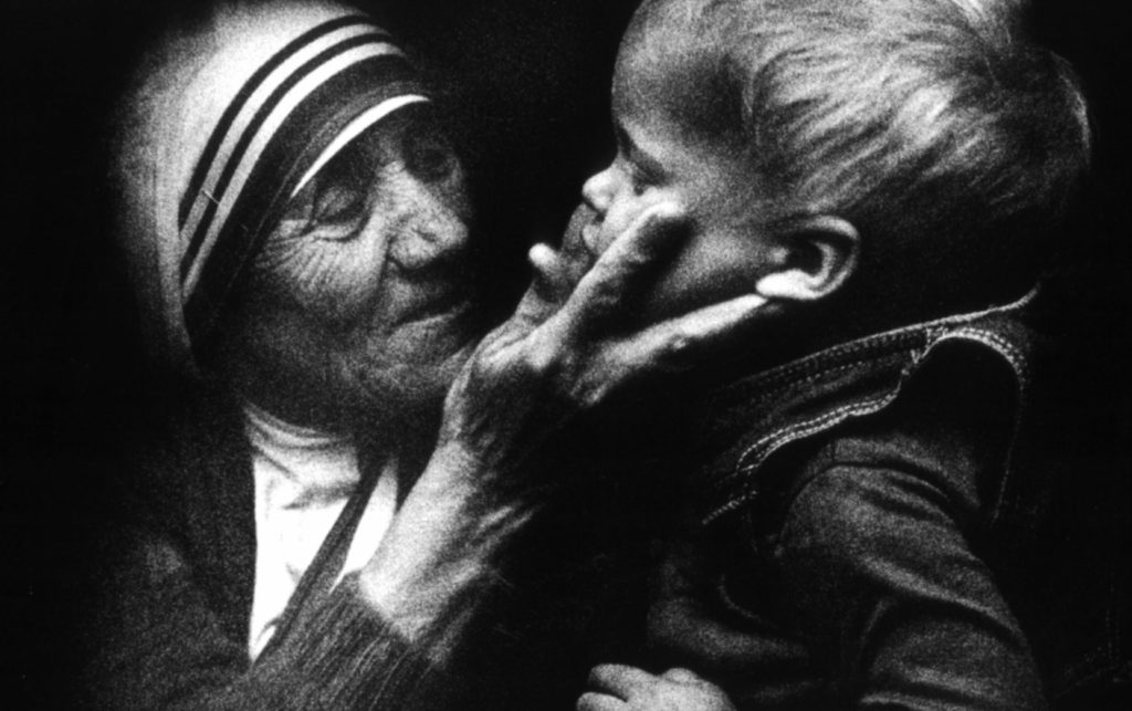 An undated file picture shows Blessed Teresa of Kolkata holding a child during a visit to Warsaw, Poland. Mother Teresa will be canonized by Pope Francis Sept. 4 at the Vatican. (CNS photo/Tomasz Gzell, EPA)