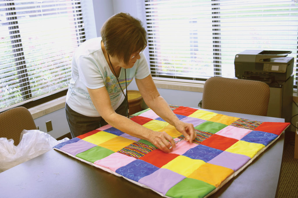 Pat Allmen works on a quilt Sept. 19 at St. Fabian Parish in Farmington Hills as part of the parish’s Quilters Block, which makes quilts to send with the youth group on mission trips across the country. 