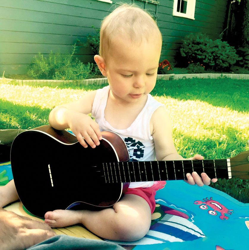 Two-and-a-half-year-old Penelope Grace Deely, who passed away Sept. 25 at the Children’s Hospital of Philadelphia, plays with a guitar in this family photo.