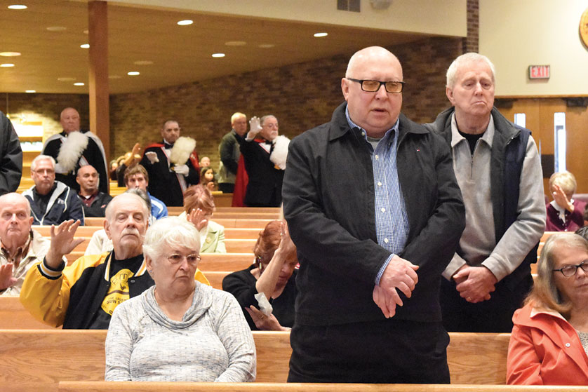 Veterans stand for a blessing Nov. 13 during a special Mass at Our Lady of the Woods Parish in Woodhaven. Dan Meloy | The Michigan Catholic