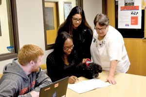 Sr. Sarah Foster, RSM, and her dog, Bentley, help mentor students in the Student Success Center a the University of Detroit Mercy on Nov. 2.  Part of Sr. Foster's Ministry involves counseling students who feel overwhelmed or lost in the transition from high school to college. (Dan Meloy | The Michigan Catholic)
