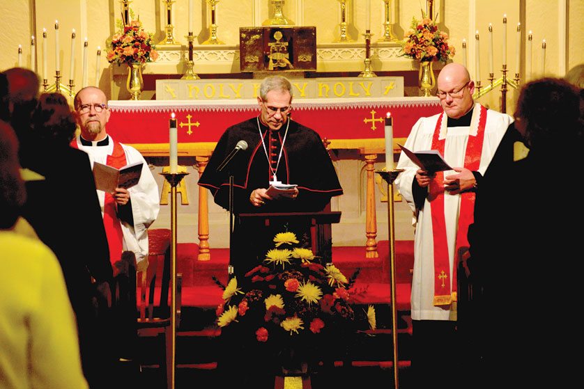Archbishop Michael J. Byrnes joins Fr. Stephen Rooney, left, pastor of Our Lady on the River Parish in Marine City, and the Rev. Troy Waite, pastor of St. Martin’s Lutheran Church, in an ecumenical prayer vigil Oct. 30 to mark the start of a year commemorating the 500th anniversary of the Protestant Reformation.  