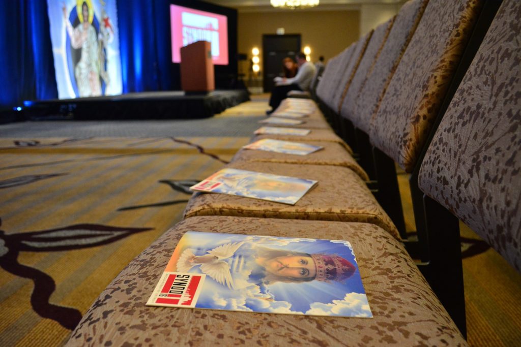 Mass programs sit on chairs before the opening procession of Synod 16 on Nov. 18 inside the Westin Book Cadillac hotel in downtown Detroit. During the opening session, Archbishop Allen H. Vigneron asked synod members to help him discern, among other things, what role "signs and wonders" might play in accompanying the proclamation of the Gospel in the modern age. (Mike Stechschulte, The Michigan Catholic)