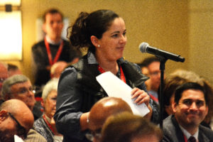 Claudia Gomez, a synod member from SS. Andrew and Benedict Parish in Detroit, speaks during the large group session on parishes Nov. 19, where members shared their thoughts on how to better equip parishes for mission. (Mike Stetchschulte | The Michigan Catholic)